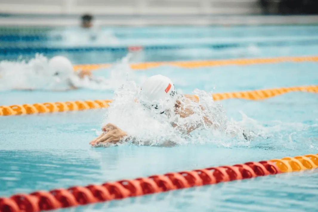 A swimmer racing in an Olympic pool