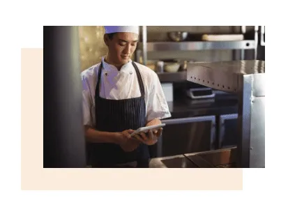 A cook records HACCP checks on a tablet