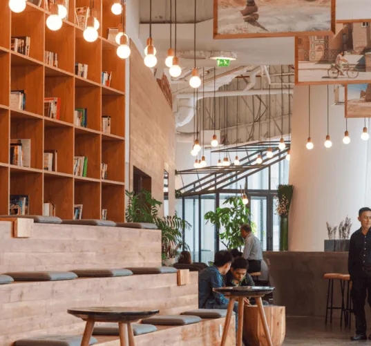 Restaurant dining room with bookshelves and seated guests